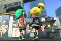 The Inkling on the left is wearing the Deep-Octo Satin Jacket.
