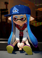 A female Inkling wearing the Squidvader Cap.