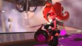 An Octoling with new gear holding a Slosher