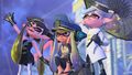The Squid Sisters waving, with the Captain between them.