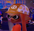 Close-up of a female Inkling wearing the Cycle King Cap.