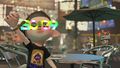 Two male Inklings wearing New Year's Glasses DX in Inkopolis Square.