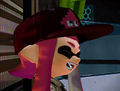 Closeup of a female Inkling wearing the Squidvader Cap.