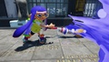 A female Inkling wearing the Full Moon Glasses flicking ink with a Permanent Inkbrush.