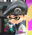A male Inkling with dark blue ink wearing a dark gray Special Forces Beret.