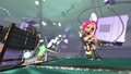 Promo of Agent 8 inside a mission, with Nintendo GameCubes as well as their controllers and discs floating in the background.