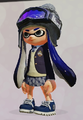 A female Inkling with Dark Blue Ink wears a dark gray Squid Nordic.