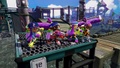 The second farthest right Inkling wields the Splattershot