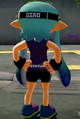 The same female Inkling wearing the Black Arrowbands, Octo Tee, and Plum Casuals, seen from the back.