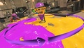 An Inkling with Dualie Squelchers next to Wave Breaker