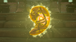 A screenshot of Riju's Secret Stone after she has claimed it. Its coloration has become orange, and an inscription appears upon it.