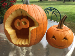 It's a pumpkin with an Inkling squid carved into it. The eyes are hanging down.