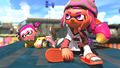 Two Inklings taking a photo at Port Mackerel in a promo image for Version 2.0.0 of Splatoon 2.
