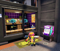 Two jellyfish in another small room with a Squid Squad poster.