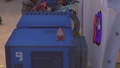 An Octotrooper plushie can be seen between a food stall and the Seashell Stage