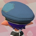 An Inkling boy with the Topknot hairstyle wearing the Cap of Legend. Unlike in Splatoon, the cap does not have a hole, so the Topknot no longer pops out of the hat.