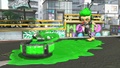 An Inkling boy with the Yellow-Mesh Sneakers throwing a Curling Bomb.