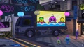 The jumbotron on the truck across the street from Crush Station on the first day of a special Splatfest, displaying the advertisements specific to the Splatfest.