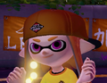 Close-up of a female Inkling wearing the Backwards Cap.