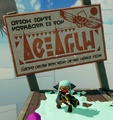 An Inkling stands in front of a sign written in round script. Much of it is gibberish.