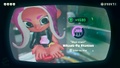 Agent 8 being awarded the Knitted Hat mem cake upon completing the station