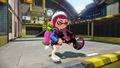 A female Inkling running with the Sploosh-o-matic 7.