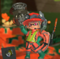 A player with the Grizzco Slosher while using the Reppin' Inkopolis Emote