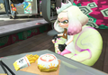 Pearl looking at a hamburger