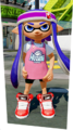 A female Inkling wearing the B-ball Headband. Note the difference between it and her ink color.