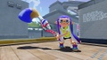 An Inkling girl wearing the Full Moon Glasses flicking ink with a Permanent Inkbrush.