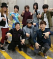 A photo of the Nintendo Special Rock Band's members as well as Mahito Yokota and Toru Minegishi. Tomomi Oda is on the top row in between Shuntaro Kado and CO-K