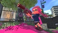 An Inkling Girl holding a Rapid Blaster Pro in between shots.