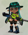 An Inkling girl wearing the Camo Zip Hoodie, partly obscured by a Hero Charger Replica.
