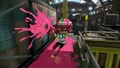 A male Inkling wearing the Crazy Arrows, firing a .52 Gal.
