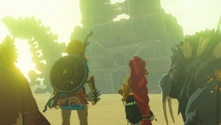 A screenshot of Riju and Link standing before Divine Beast Vah Naboris, which has collapsed to the ground. Their Sand Seals are positioned at either side of them.