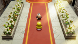 A screenshot of Princess Zelda standing in front of Impa in a hallway in Hyrule Castle