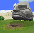 Link lifts a Stone Head to reveal a secret hole on Stone Watcher Island