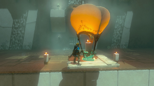 A screenshot of Link standing atop a contraption made with a Board, a Candle, and a Balloon. He is rising into the air.