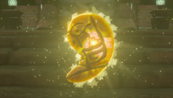 A screenshot of Riju's Secret Stone after she has claimed it. Its coloration has become orange, and an inscription appears upon it.