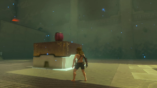 A screenshot of Link standing in front of a platform with a Bomb Barrel sitting on its top.