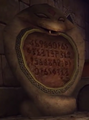 A statue depicting a cobra with writing in the Spirit Temple from Ocarina of Time