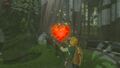 Link qui reçoit un réceptacle de coeur après avoir prié devant la statue de la déesse Hylia dans Breath of the Wild.